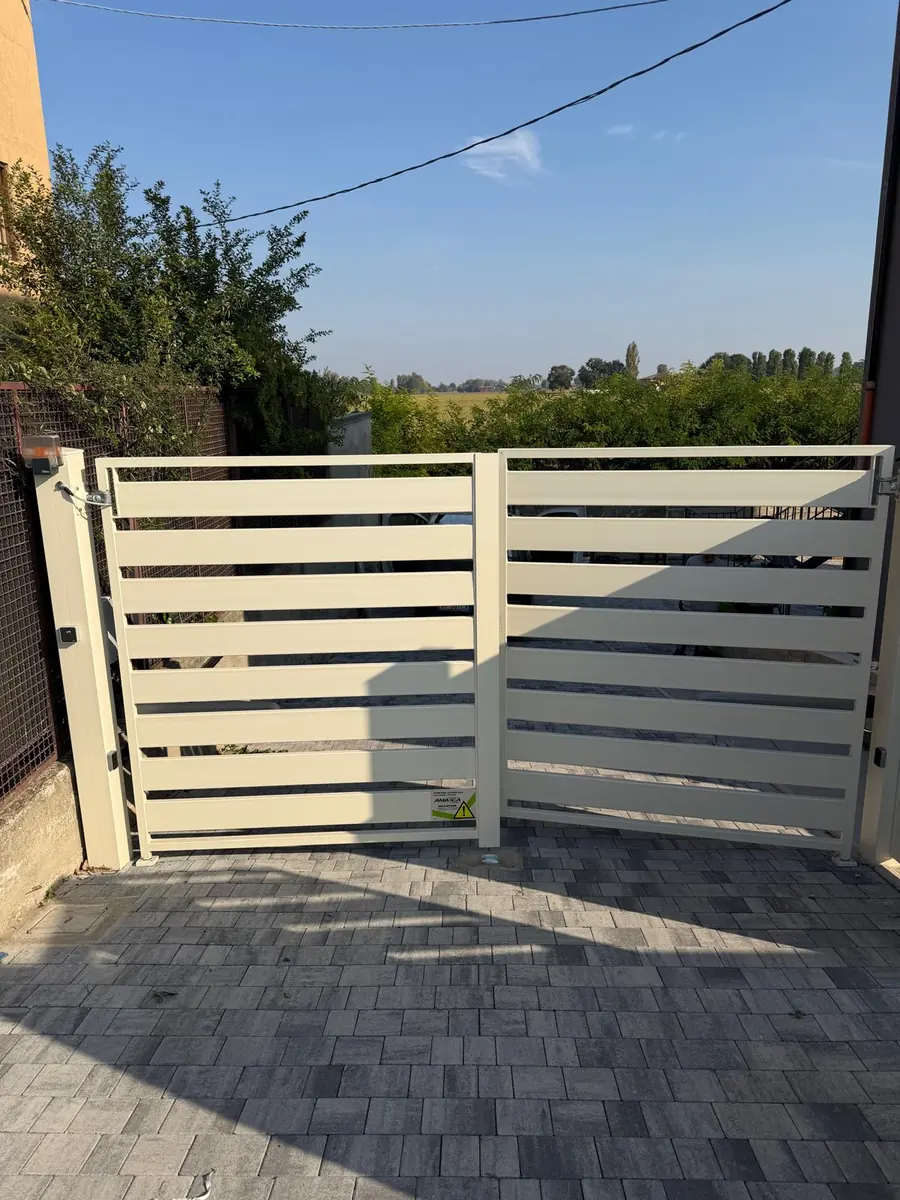 Cancello a battente con doghe orizzontali chiare in campagna – assistenza Telcoma Lugo